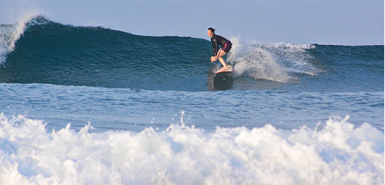 Amy Waeschle surfing a right-breaking wave near Troncones, Mexico.