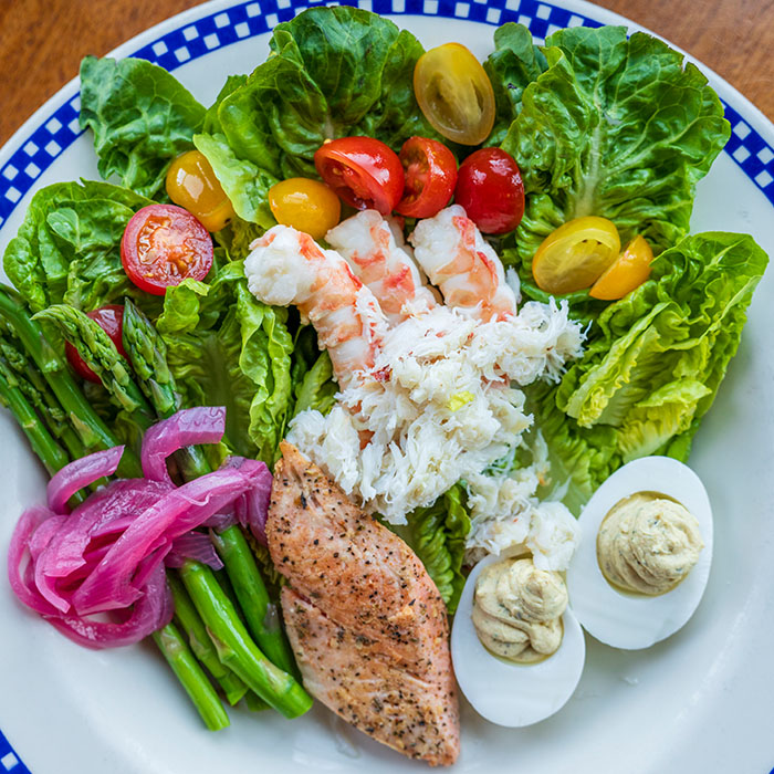 Duke's Seafood with prawns, salmon, crab, deviled eggs, asparagus, onions, and tomatoes